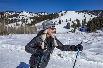 Senior female hiker hiking in mountains in winter