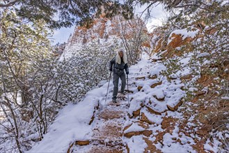 Senior woman hiking in mountains in winter