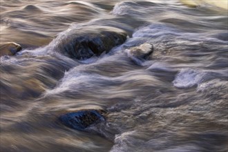 Blurred image of water running on stones