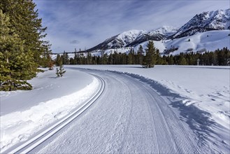 Snow-covered mountains with dirt road