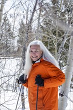 Smiling woman snowshoeing in winter