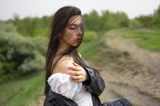 Portrait of teenage girl standing in nature