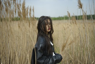 Portrait of teenage girl standing in field
