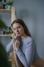 Portrait of woman looking at camera at home