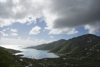 Thick clouds over Coral Bay with sailboats