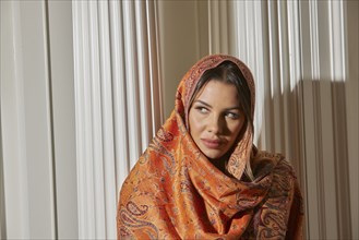 Portrait of woman wrapped in shawl