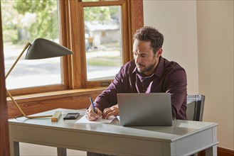 Man working at desk at home