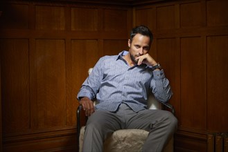 Portrait of mid adult man sitting on chair