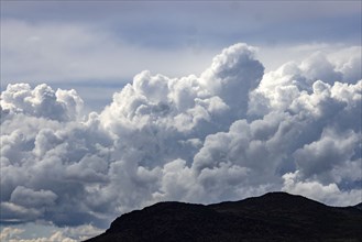 Majestic cumulus clouds above mountains
