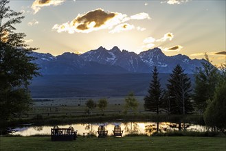 Scenic view of Sawtooth Mountains with pond at sunset