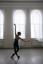 Back view of ballerina dancing at studio