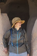 Woman in straw hat at Puye Cliff Dwelling