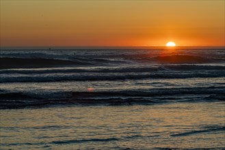 Sun setting over ocean at Cannon Beach