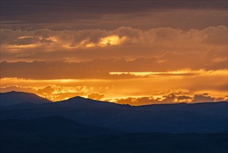 Beautiful sunset over silhouettes of mountains
