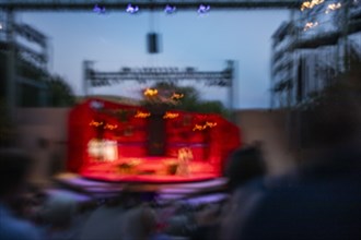 Blurred motion of stage at outdoor theater at dusk