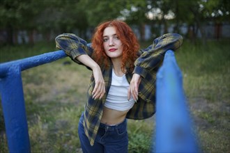 Redhaired woman posing at playground
