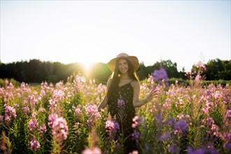 Portrait of smiling woman in meadow on sunny day