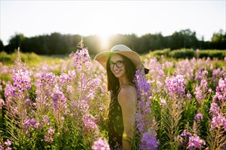 Portrait of smiling woman standing in meadow