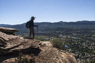 Usa, Colorado, Durango, Woman standing on ledge in San Juan Mountains