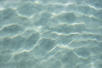 USA, United States Virgin Islands, St. John, Patterns in sand beneath light reflecting on water