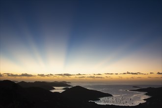 USA, United States Virgin Islands, St. John, Sunbeams over Caribbean Sea at sunset