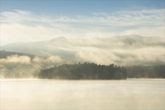 USA, NY, Island on Lake Placid in morning mist