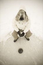 USA, NY, Hammond, High angle view of man ice fishing on frozen Black Lake