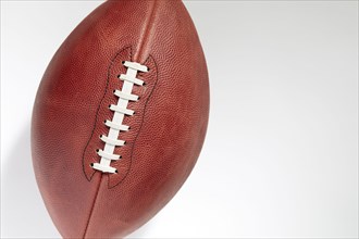 Overhead view of American football ball on white background