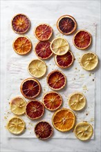 Overhead view of baked citrus slices on baking paper