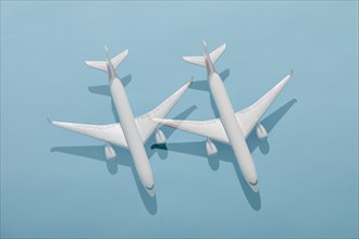 Overhead view of two model planes on blue background