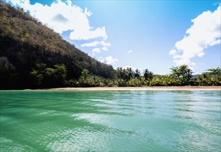 Turquoise water and hills on sunny day