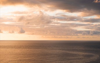 Clouds over sea at sunset
