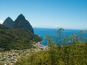 Town in hilly landscape with sea in background