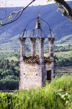 Old church bell tower in hilly landscape