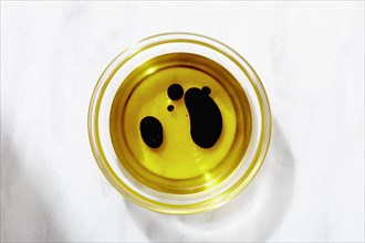 Overhead view of bowl of olive oil and balsamic vinegar