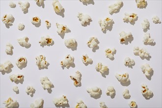 Overhead view of popcorn on white background