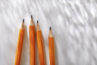 Overhead view of pencils on white background
