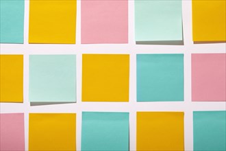Rows of colorful blank adhesive notes on white background