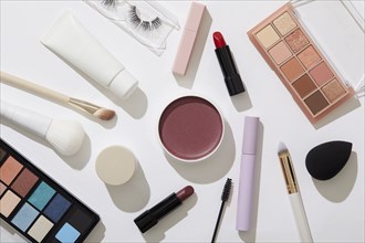 Overhead view of beauty and makeup products on white background