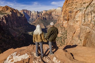 Rear view of senior couple looking at Zion Canyon from Zion Overlook