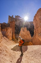 Portrait of smiling woman hiking in Bryce Canyon National Park on sunny day