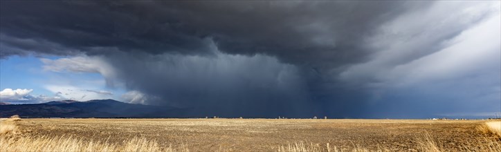 Dramatic storm clouds over field