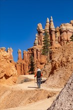 Rear view of woman with backpack hiking in Bryce Canyon National Park