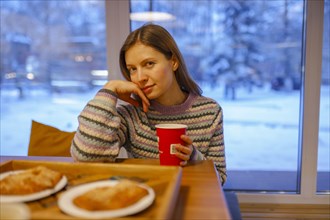 Portrait of woman having breakfast in cafe