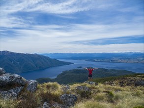 Portrait of hiker with arms outstretched in Fiordland National Park