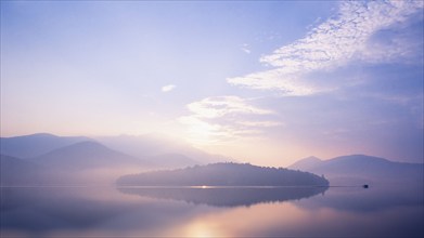 Mist rising over Lake Placid at sunrise, Lake Placid, New York, USA