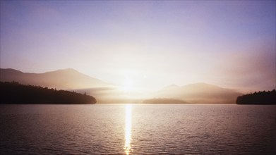 Sunrise over calm Lake Placid, Lake Placid, New York, USA