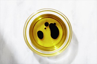 Overhead view of bowl of olive oil and balsamic vinegar, New York, NY, USA