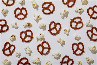 Overhead view of pretzels and popcorn on white background, New York, NY, USA