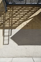 Shadows on concrete and brick wall, New York, NY, USA